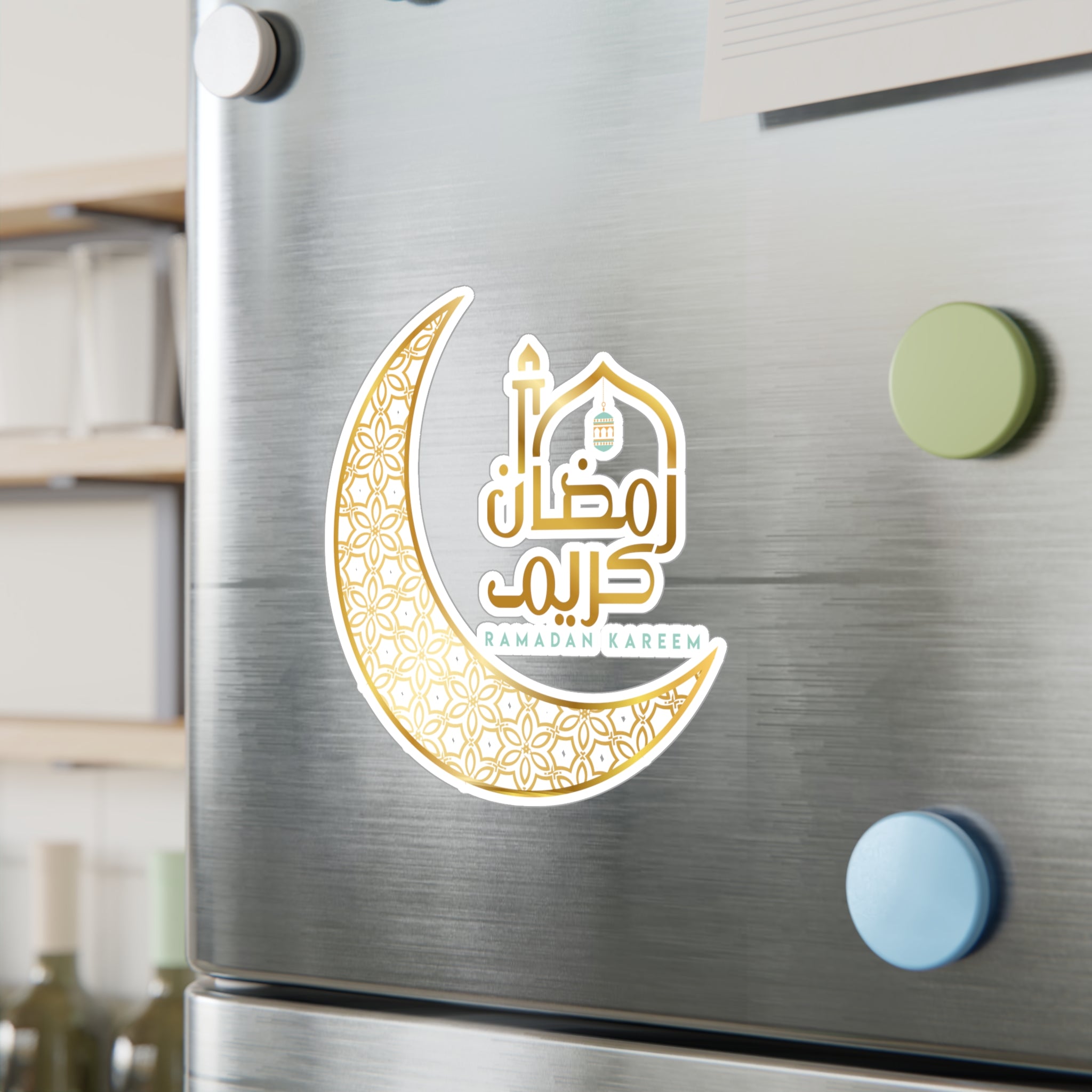 A Ramadan Kareem vinyl decal fridge magnet with crescent and mosque design on a stainless steel refrigerator door from Medina Roots.