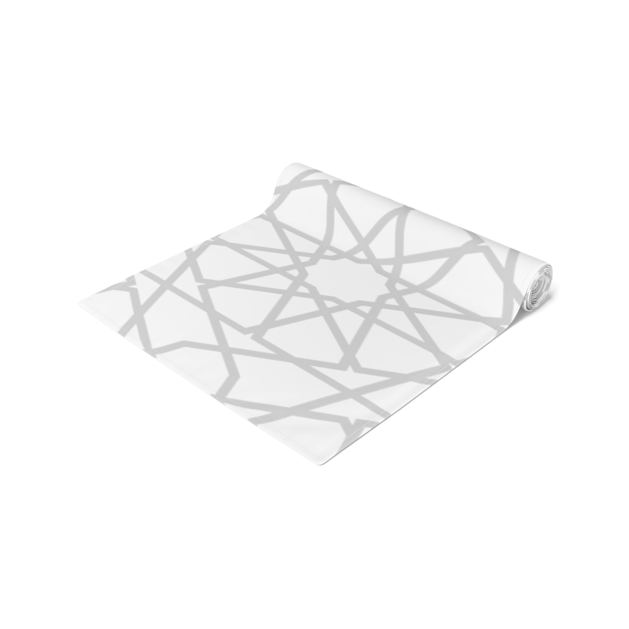 A rolled-up Vintage-Inspired Geometric Patterned Table Runner by Medina Roots with a gray geometric pattern on a white background.