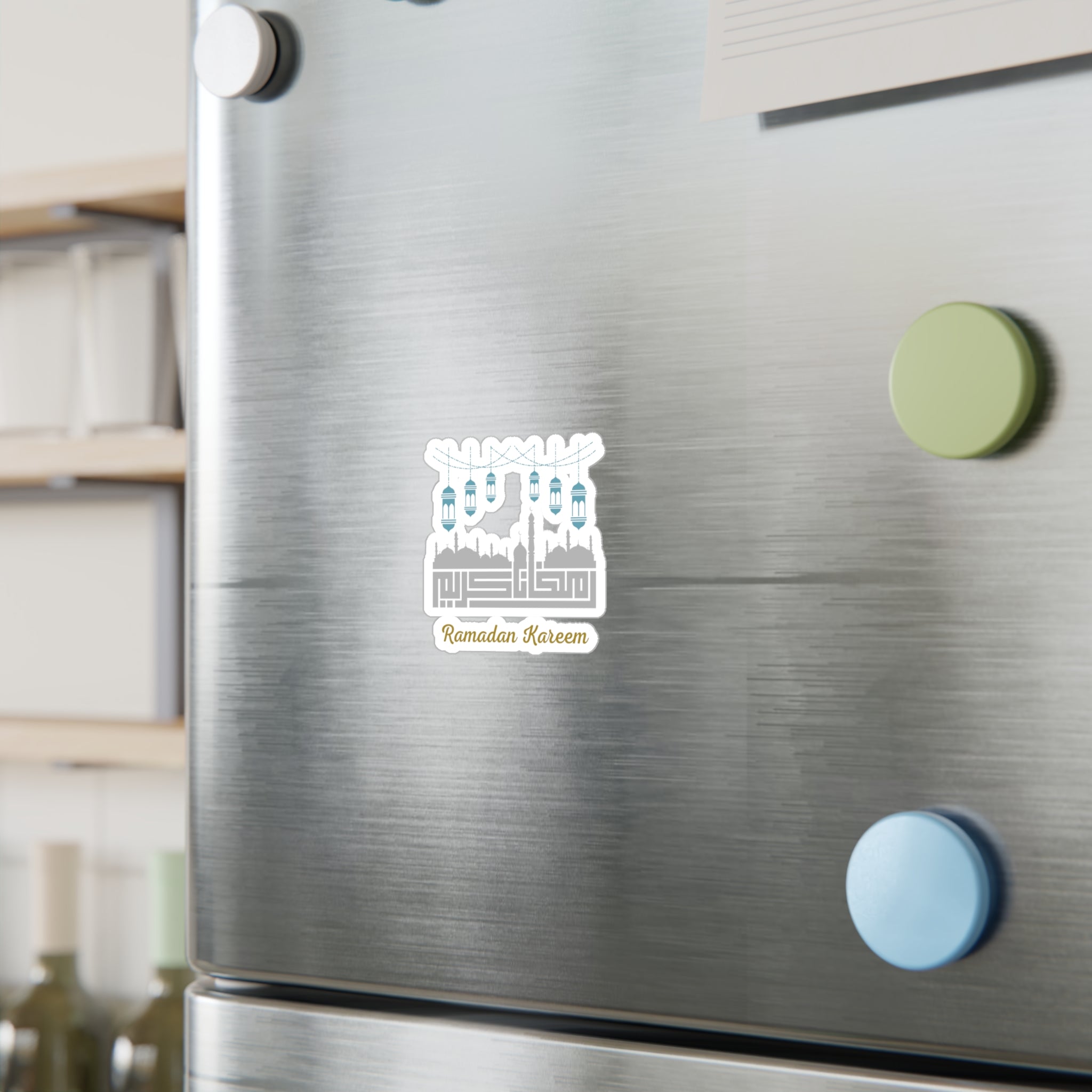 A stainless steel refrigerator with a Ramadan Kareem Kiss-Cut Vinyl Decal from Medina Roots elegantly placed on the door.