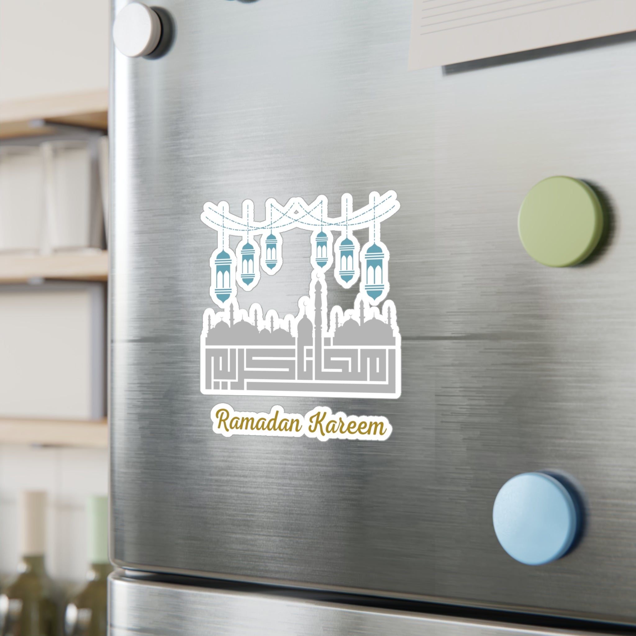 A refrigerator door with a "Ramadan Kareem Kiss-Cut Vinyl Decal" by Medina Roots and colorful round magnets.