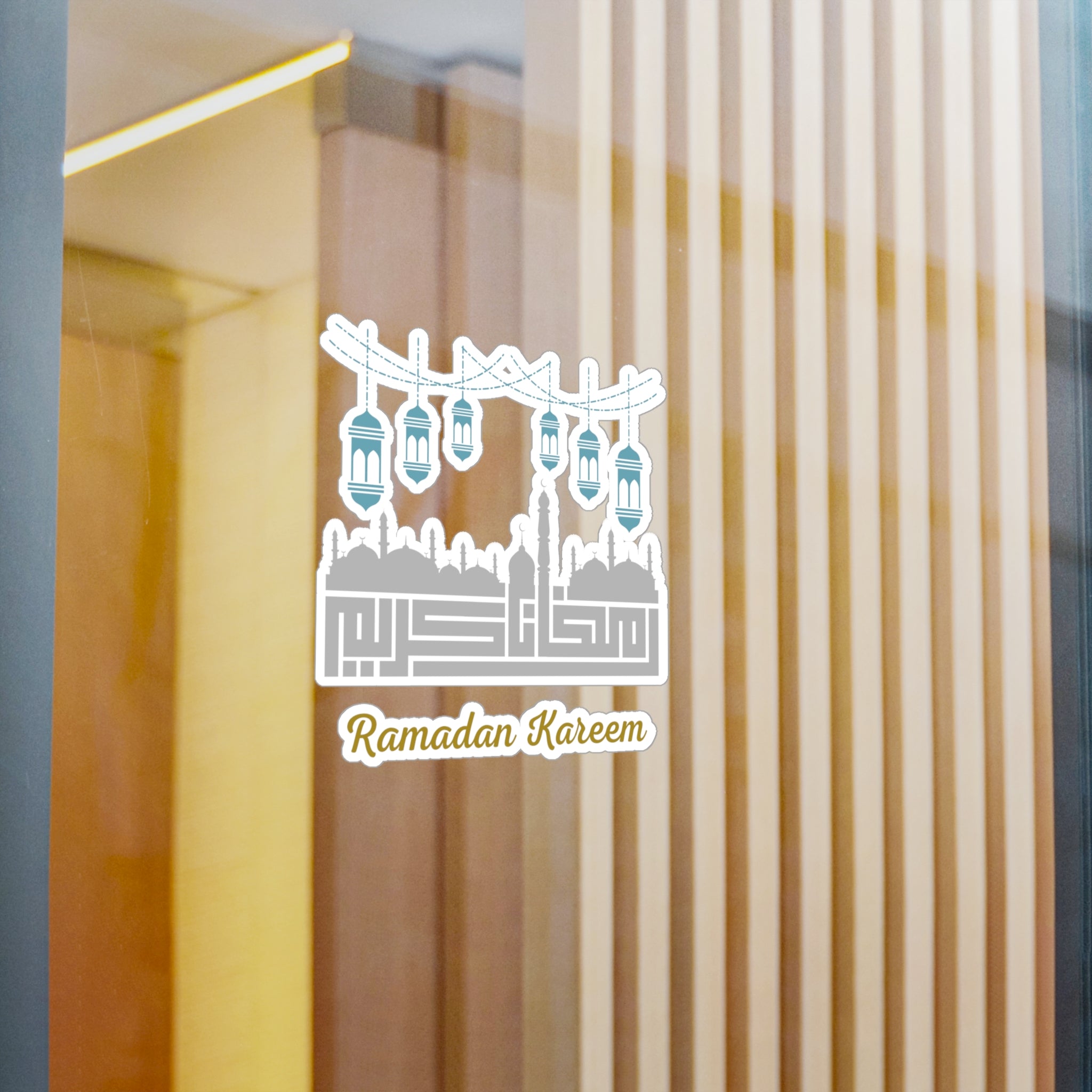 A glass door with a "Ramadan Kareem" Kiss-Cut Vinyl Decal featuring lanterns and a mosque silhouette by Medina Roots.