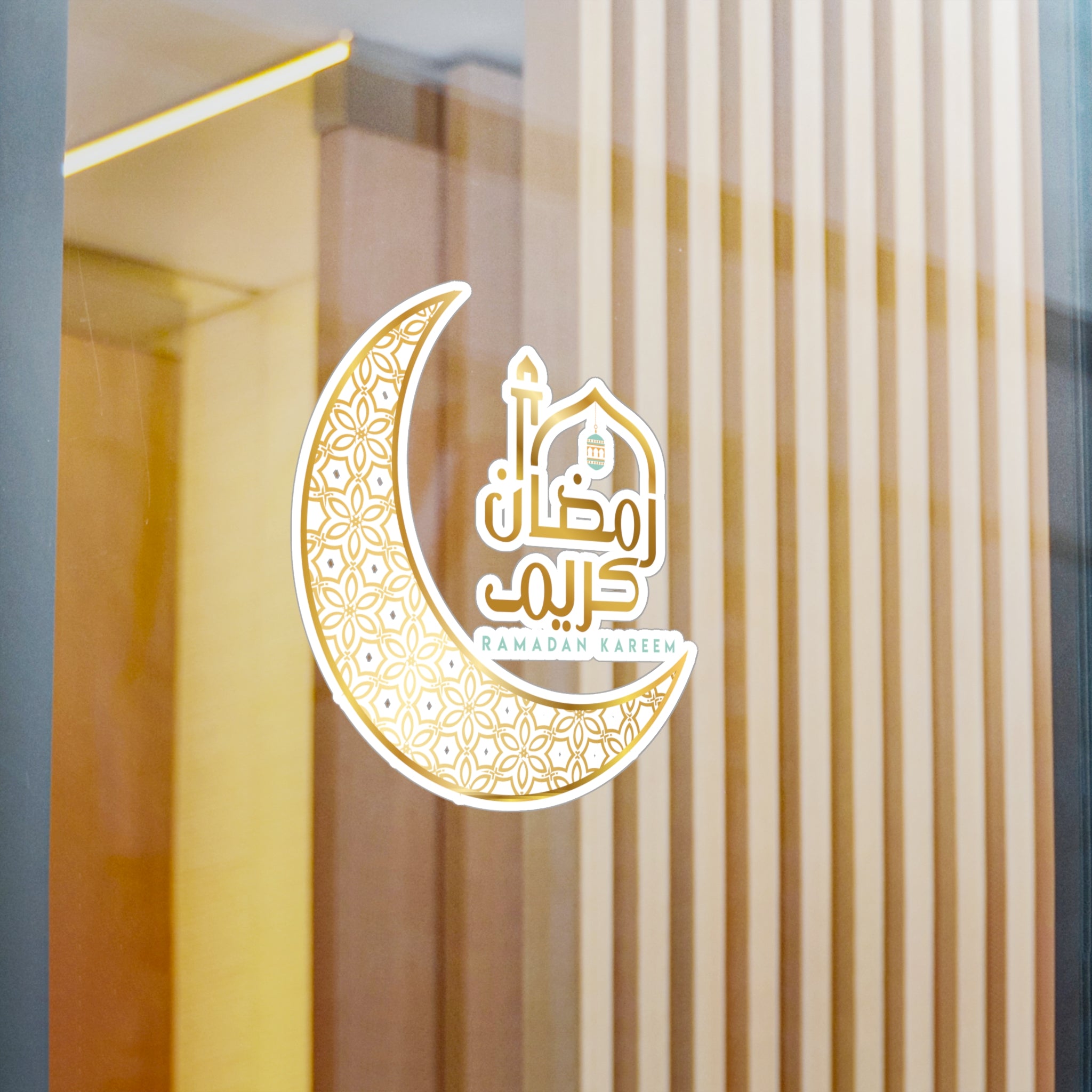 Crescent moon and mosque silhouette sticker with "Ramadan Kareem" text on a glass window, signifying the celebration of the holy month of Ramadan is the Medina Roots Ramadan Kareem Transparent Outdoor Sticker.