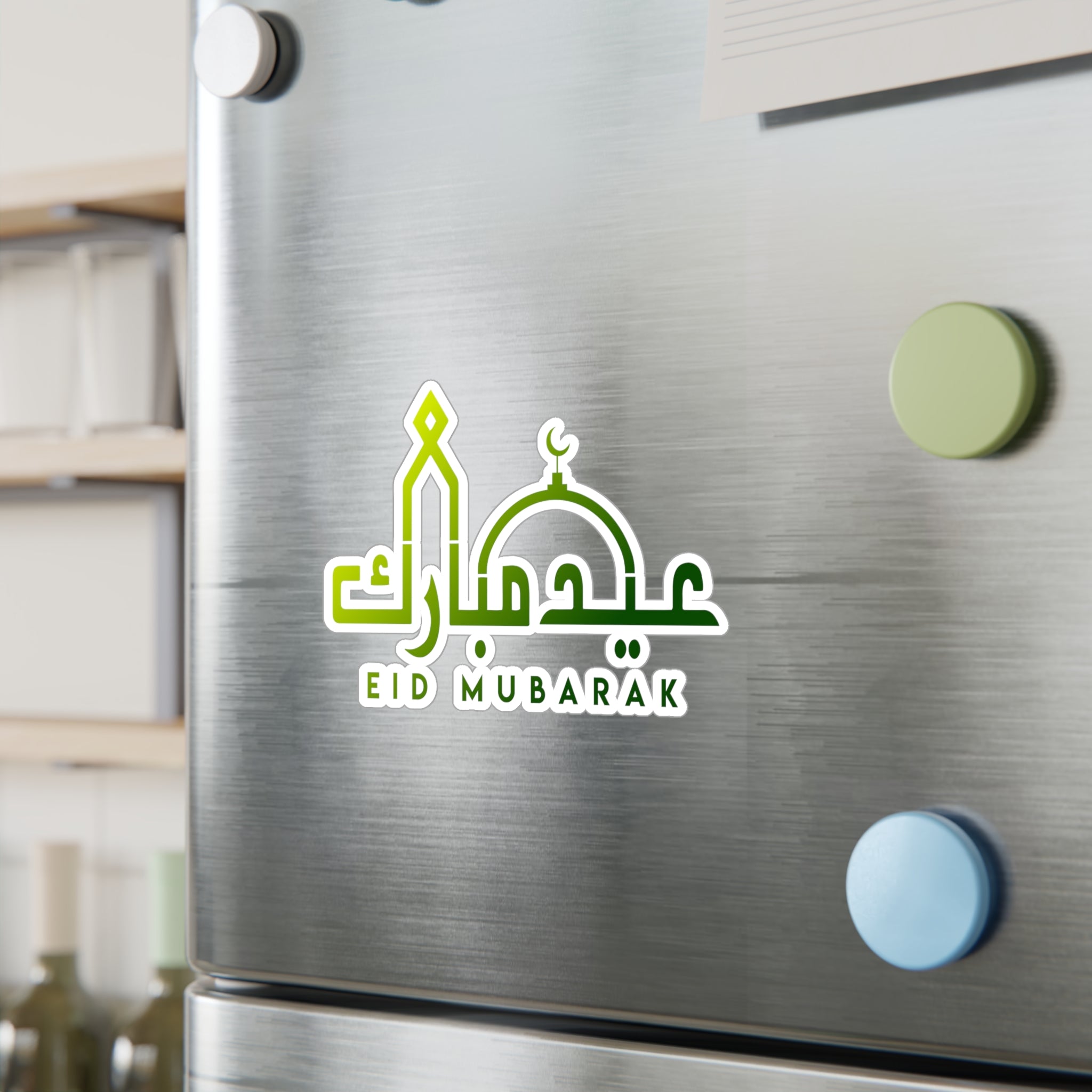 Magnets with "Eid Mubarak" calligraphy, serving as festive decor on a stainless steel refrigerator. 

Eid Mubarak Transparent Outdoor Stickers by Medina Roots, Die-Cut, 1pcs. Muslim, Eid. Islamic. Ramadan. Window Decal. Car Decal