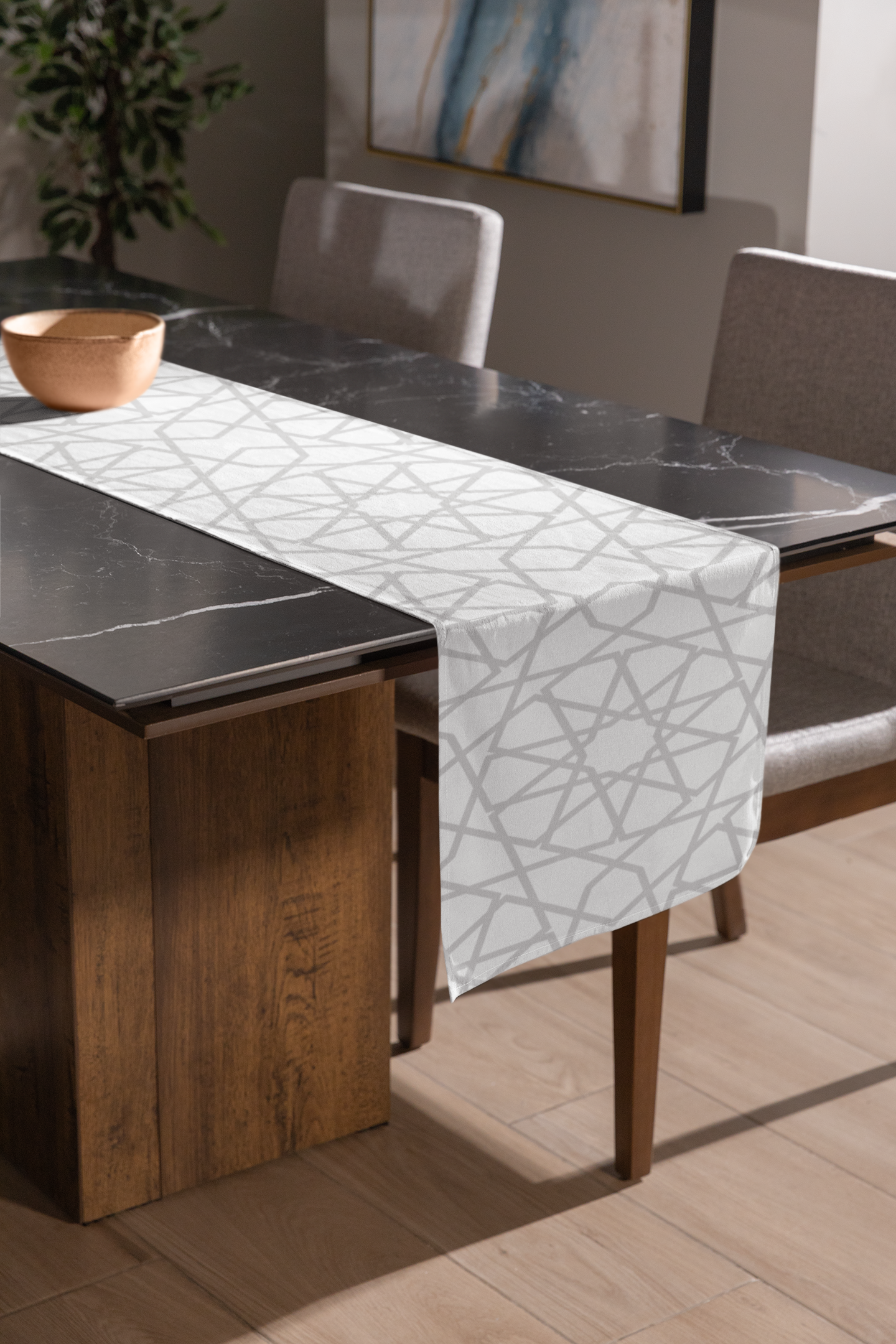 Modern dining room with a black marble table partially covered by a Vintage-Inspired Geometric Patterned Table Runner from Medina Roots, accompanied by upholstered chairs under natural lighting, exuding a vintage charm.